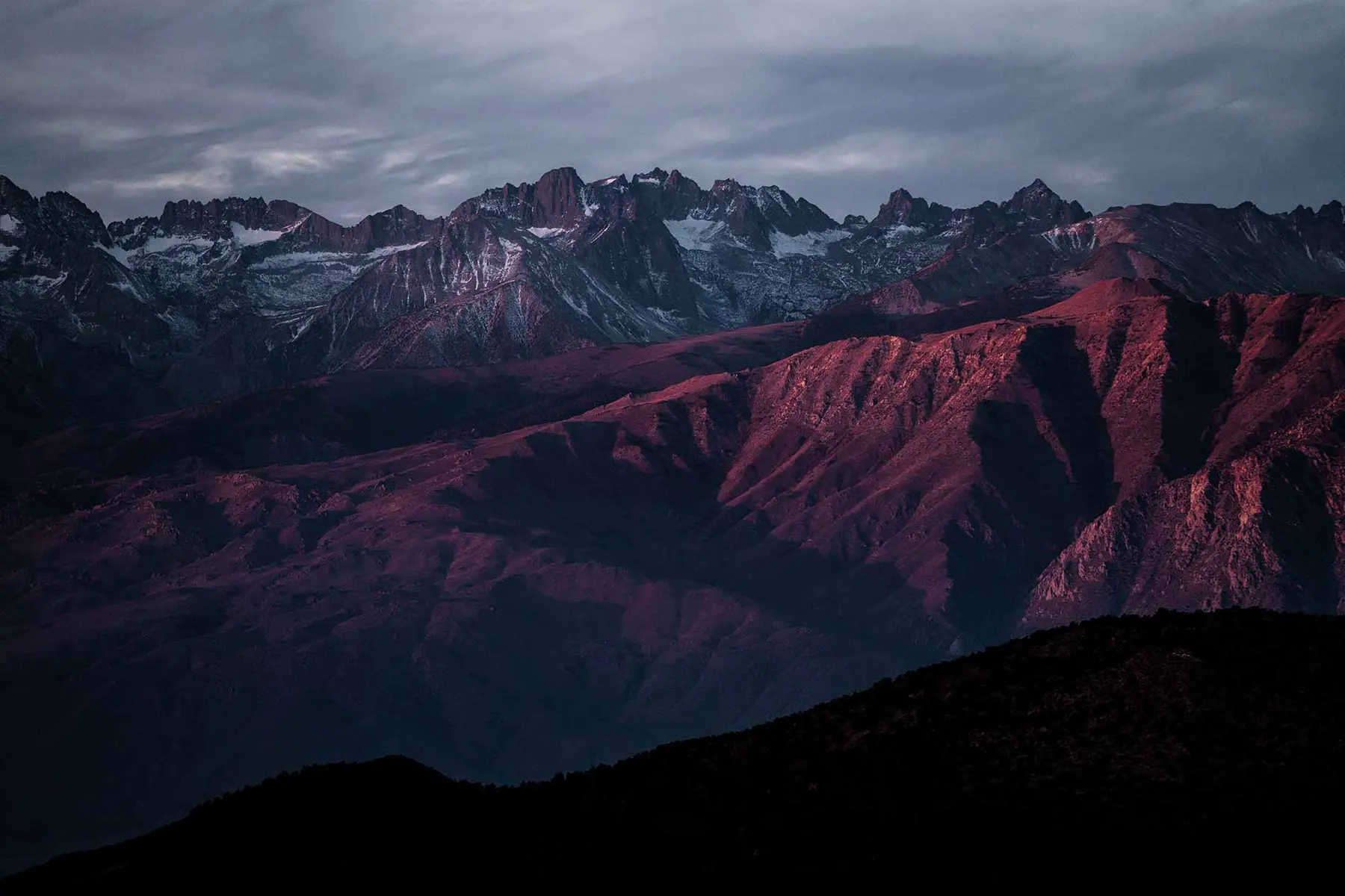 Rugged Colorado peaks glowing red at sunset