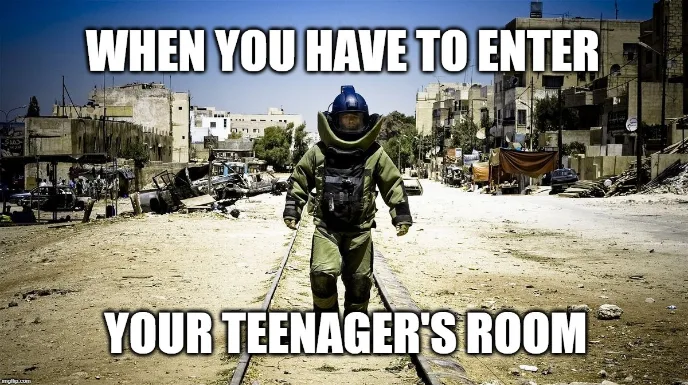 A person in a bomb disposal suit walks down a damaged street. Text over image reads: When you have to enter your teenagers room..