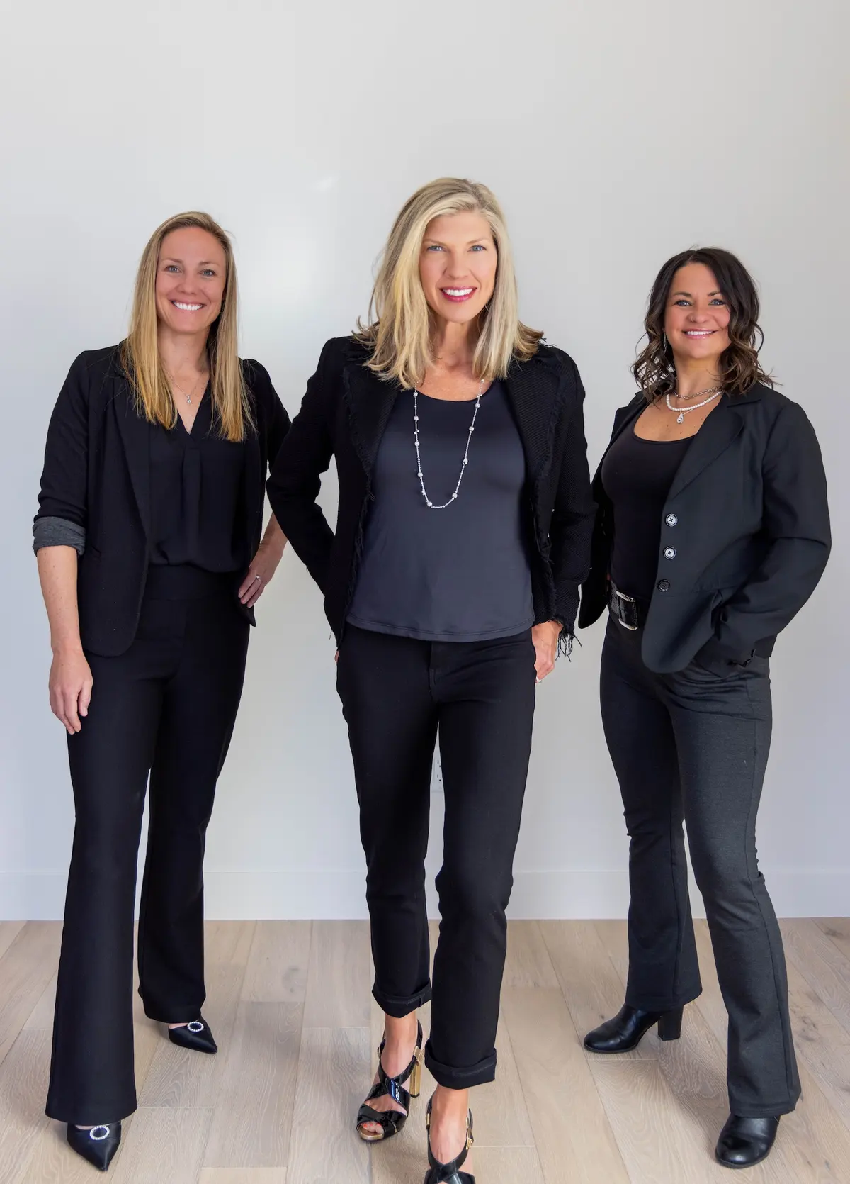Candice De, Amy Nakos, and Jennifer Luberto standing together in black blazers