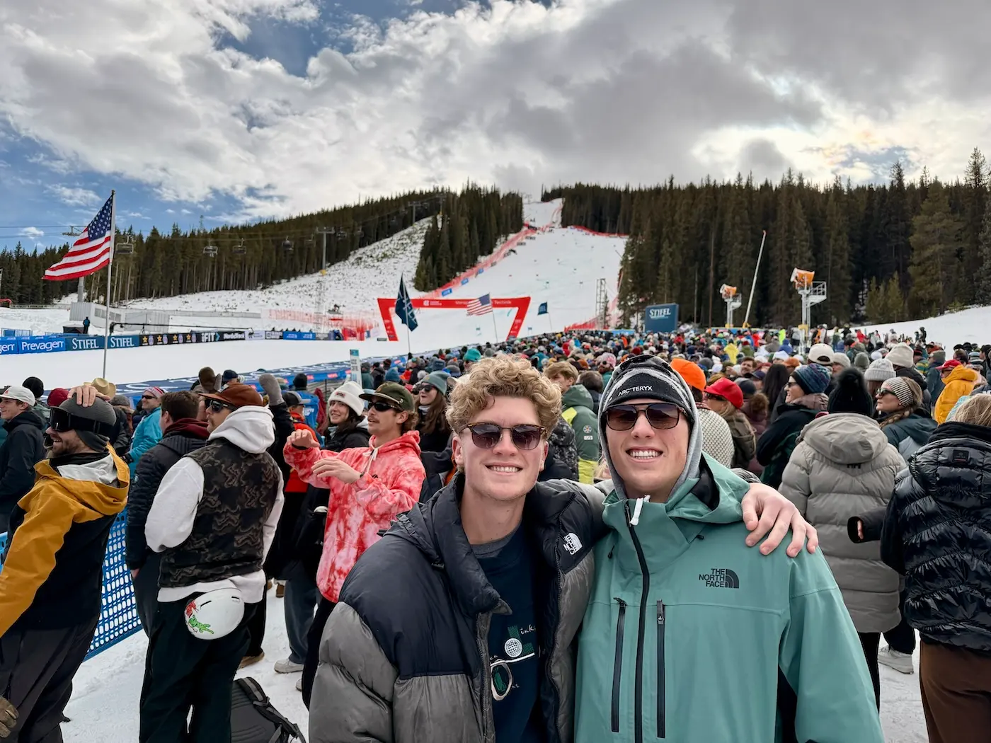 Spectators at a ski competition at Copper Mountain with the race course and forested slopes behind
